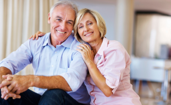a mature couple smiling with dental implants