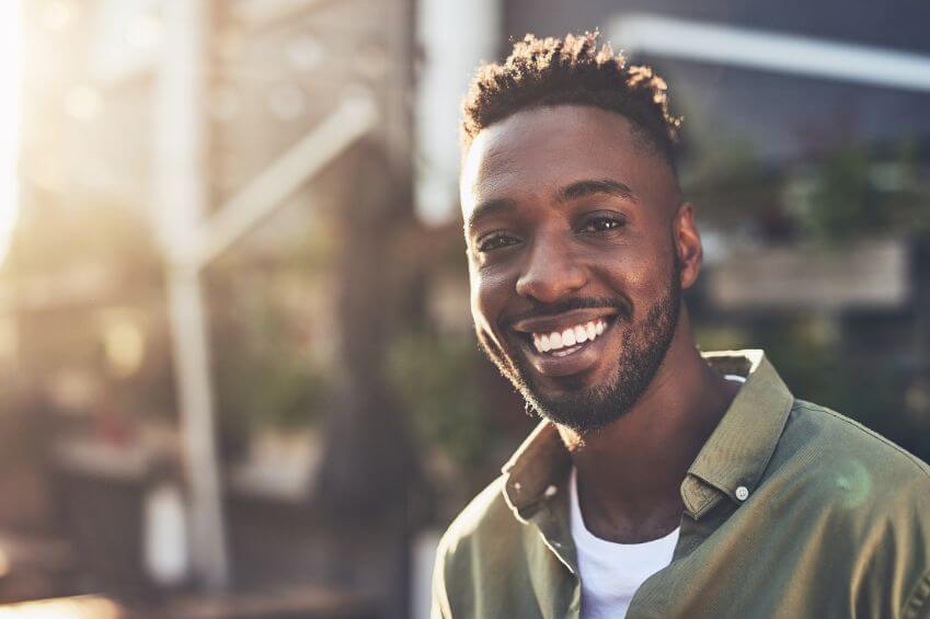 Man smiling - straight teeth after Invisalign treatment