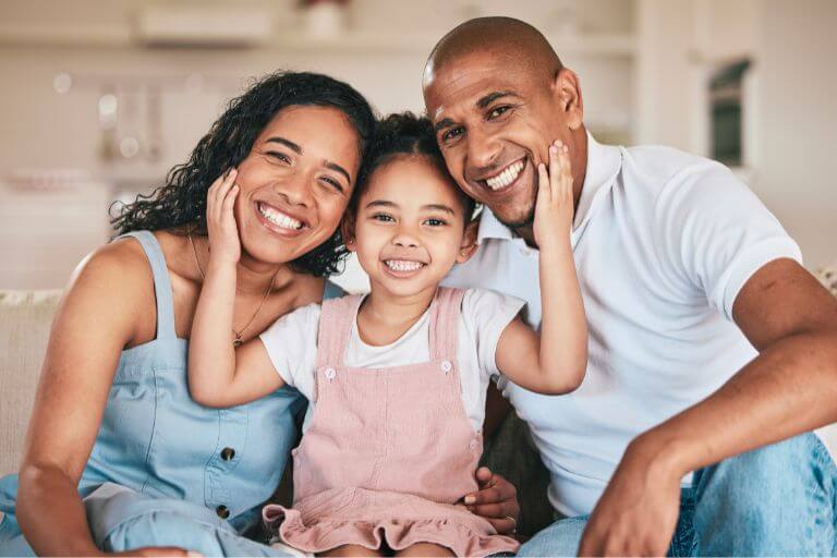 3 family members sat down smiling